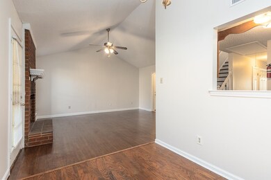 Unfurnished living room featuring ceiling fan, a t