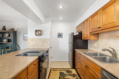 Kitchen featuring sink, tasteful backsplash, stain
