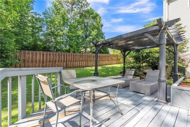 Wooden deck with a pergola and outdoor dining area