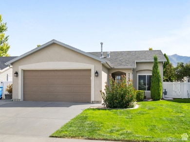 View of front of house with concrete driveway, a garage, and stucco siding