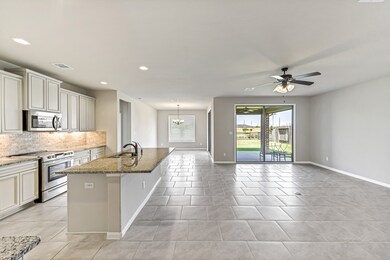 Gorgeous eat-in island with room for plenty of seating for casual dining.  The beautiful granite countertops are complimented  with tile backsplash, tall kitchen cabinets and under-counter lighting.