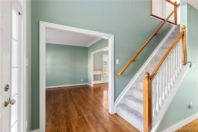 Formal living room off of the foyer w/ crown moldi