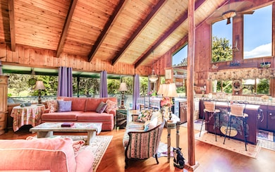A true mountain home: Redwood & Cedar, Mahogany flooring, open beam ceiling, an Ohia support post and Koa fireplace mantle!
