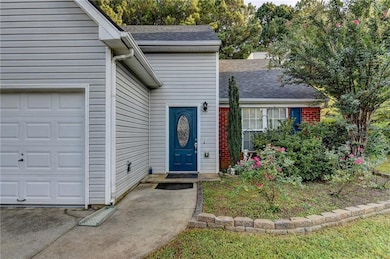 Doorway to property featuring roof with shingles