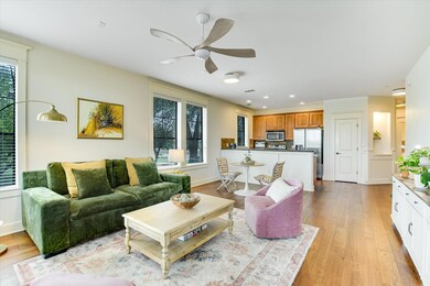 Living area featuring a ceiling fan, light wood-s