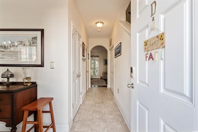 Hall with arched walkways and light tile patterned floors