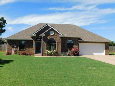 Front of house with beautiful roses and lush yard.