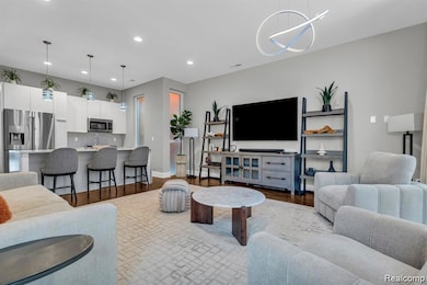 Living room featuring light wood-style flooring and recessed lighting