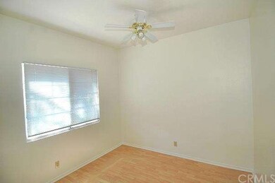 One of two bedrooms, each with ceiling fans