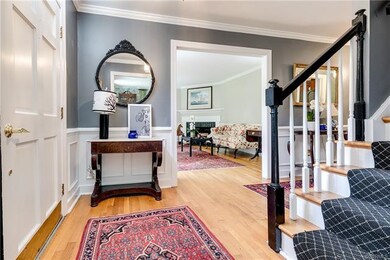 Entry foyer is beautiful, with custom trim and moldings, hardwood floors, wonderful sight lines to the living, dining and family rooms.
