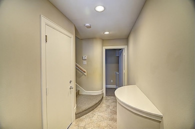 This photo shows a well-lit, narrow hallway with n