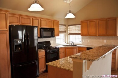 Kitchen has granite surfaces, corner windows let i