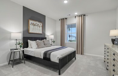 Bedroom with light colored carpet, baseboards, and recessed lighting