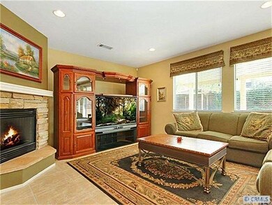 Family room with raised hearth fireplace.