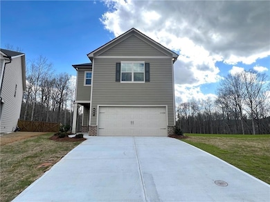 Traditional home with an attached garage, fence, d