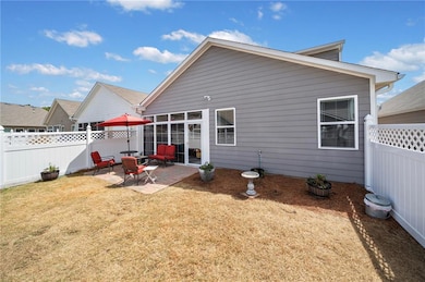 Rear view of house with a yard, fence private yard