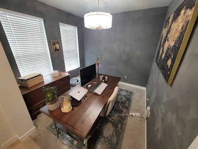 Office with baseboards and a chandelier