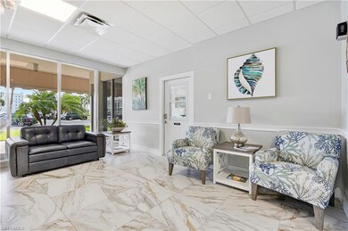 Living area featuring marble finish floor, a panel