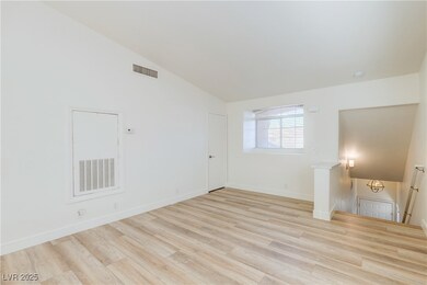 Empty room with baseboards, high vaulted ceiling,