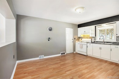Kitchen and dining area, open to living room.