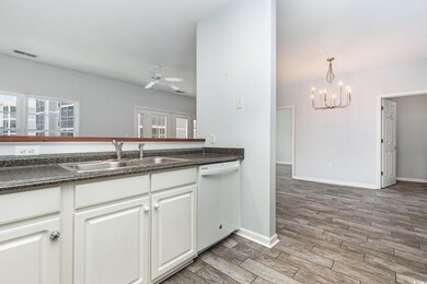 Kitchen featuring wood-type flooring, dishwasher, 