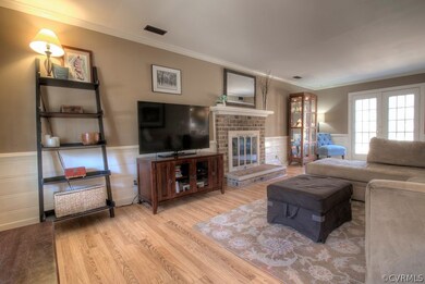 SPACIOUS family room features a brick, wood-burnin