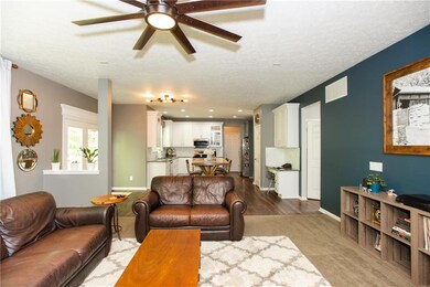 Home features an open concept flow from living room to kitchen and out to the deck!