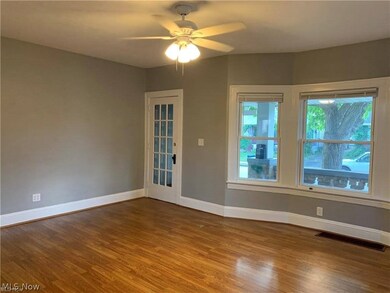 Empty room featuring ceiling fan and dark hardwood / wood-style floors