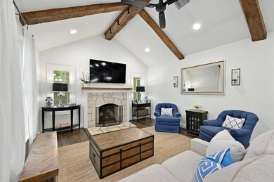 Living room with wood finished floors, recessed l