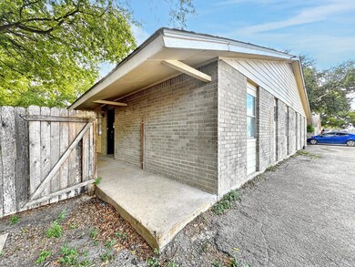 View of side of property with brick siding and fe