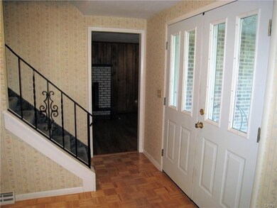 Entry foyer.  Note the parquet floor.  The family 