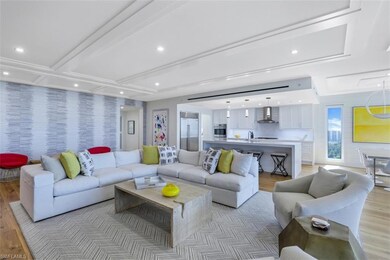 Living area with light wood-type flooring and recessed lighting