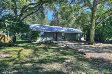 Single story home with a metal roof and a porch