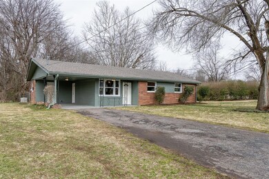 Carport and driveway.  Large front yard.