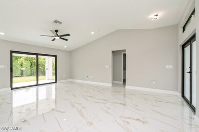 Living room with light, til floors, a ceiling fan,