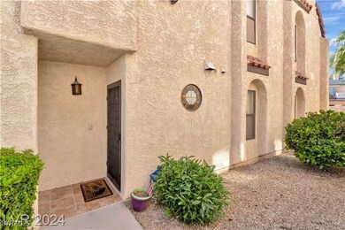 Doorway to property featuring stucco siding