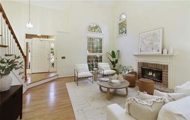 The dramatic two-story living room is filled with 