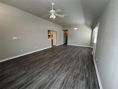 Spare room featuring dark wood finished floors, v