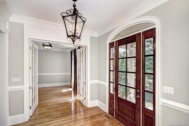 Open Foyer with Front Door and Transoms with Antiq