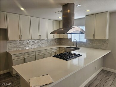 Kitchen featuring island range hood, light counter