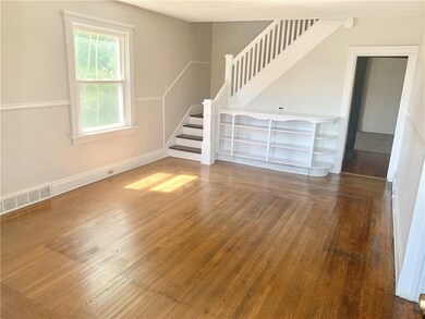 FRESHLY PAINTED LVING ROOM WITH ORIGINAL HARD WOOD