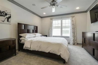Bedroom with recessed lighting, a ceiling fan, orn