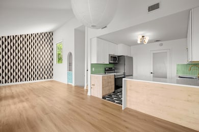 The living areas flow seamlessly into the kitchen