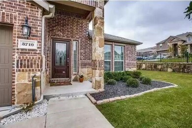 Doorway to property featuring stone siding, brick 