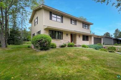 View of front of house with a garage and a front y