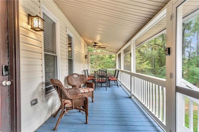 Wooden deck featuring covered porch and ceiling fan