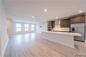Kitchen featuring stainless steel refrigerator wit