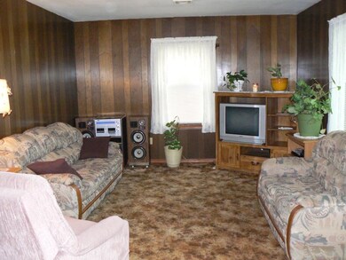 The living room has a large picture window that fa