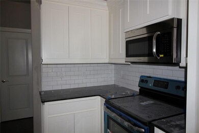 Gorgeous shaker style cabinetry with subway tile backsplash, granite countertop