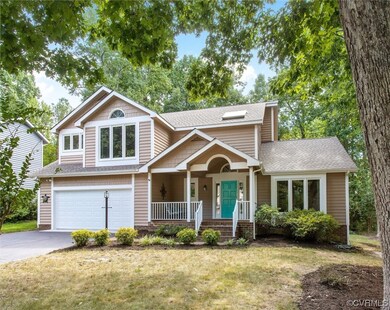 View of front facade featuring garage, a porch, and a front yard